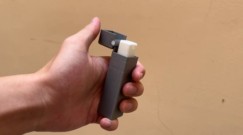 Actual physical flip-cap prototype held in a hand